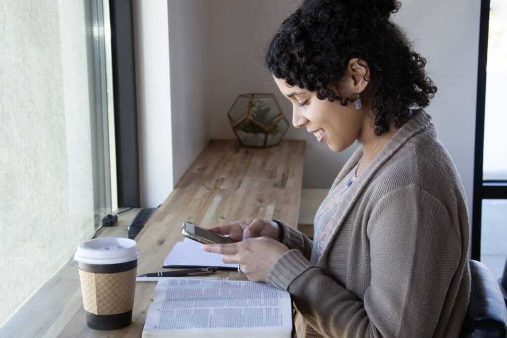 Lady Bible Studying with Bible and Phone